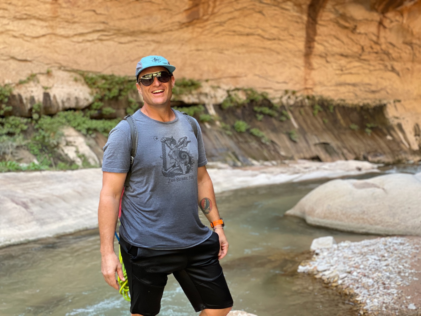 Cody laughing mid-river in a canyon